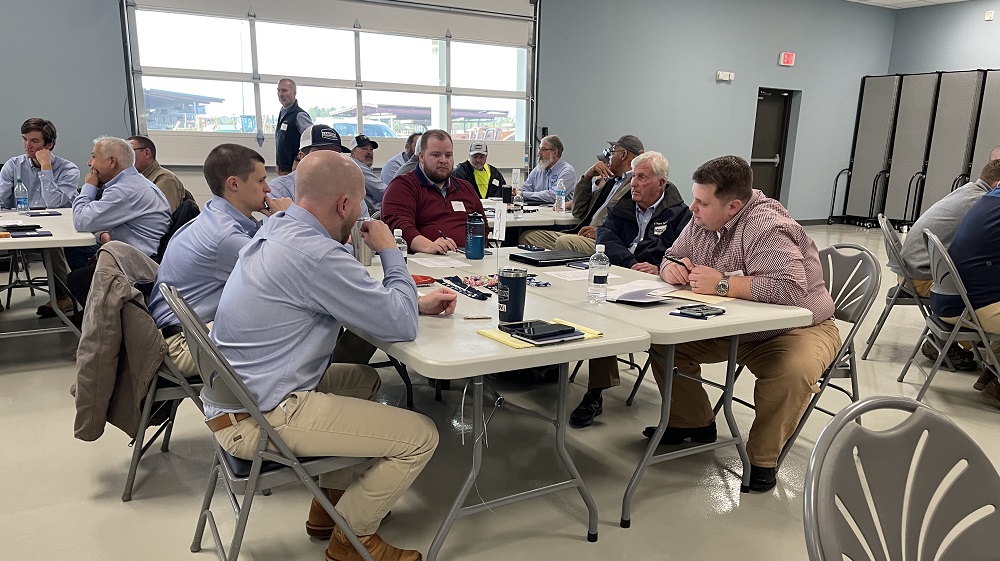 Five SCI Team Members talking around a table