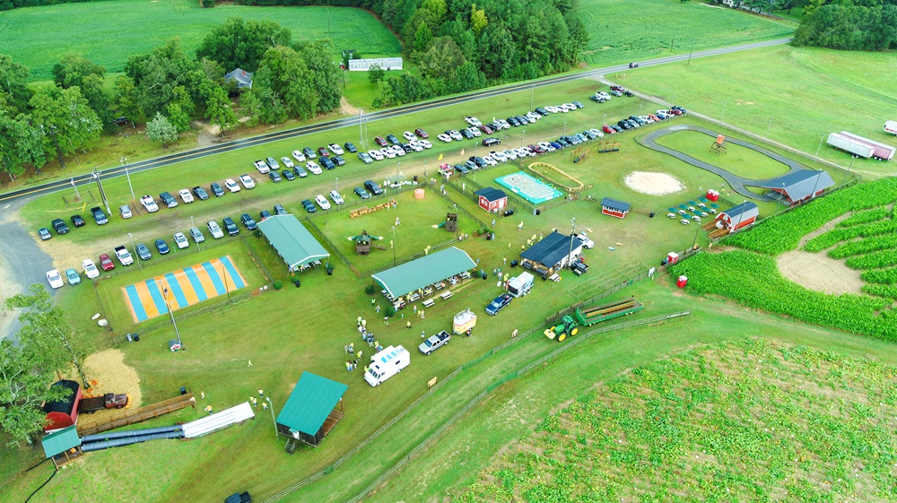 Aerial photo of farm with cars and buildings