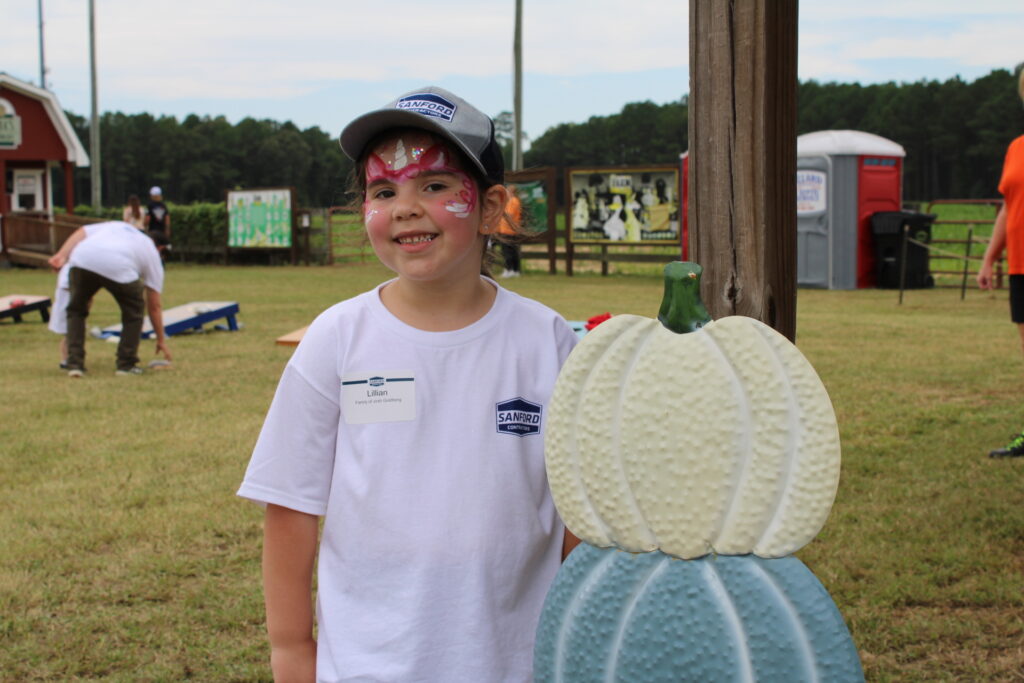 SCI child wearing SCI swag after getting her face painted 